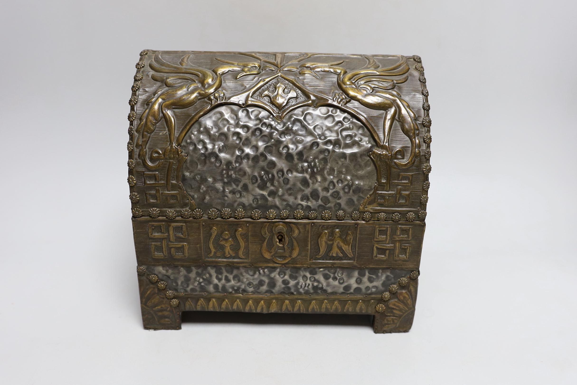 An early 20th century hammered pewter and brass neo-gothic casket, with poker work and velvet interior, 22cm high